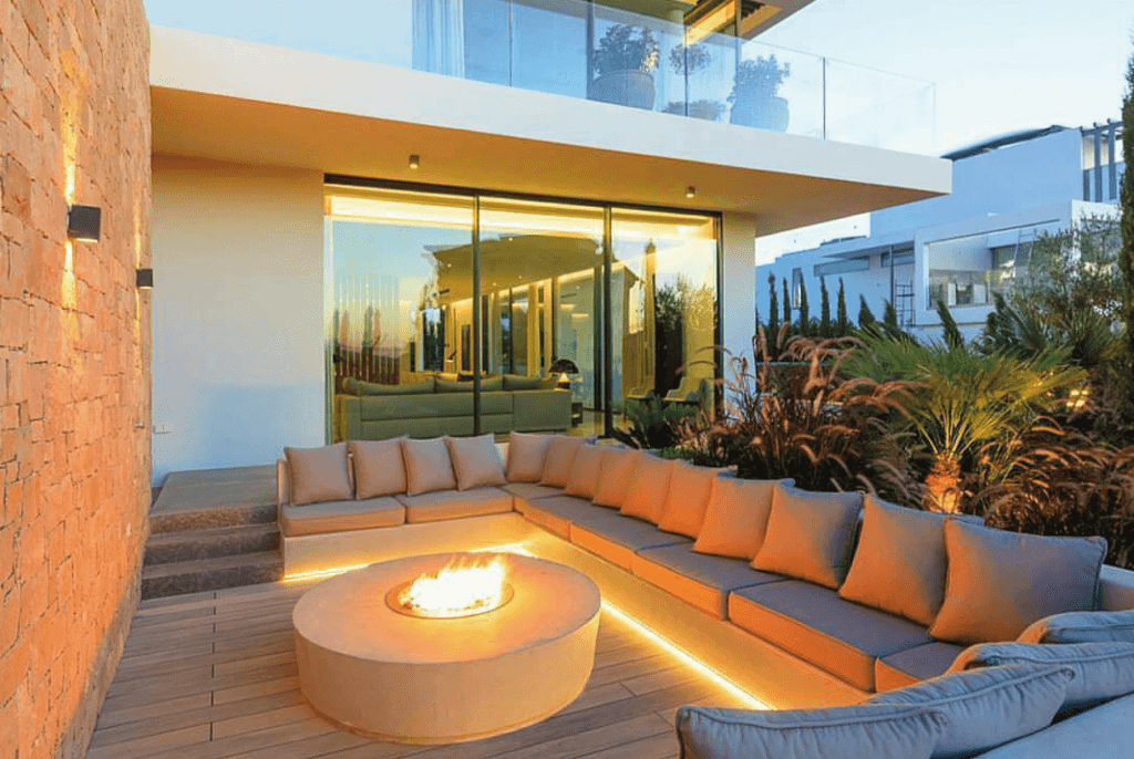 Zarzuela fire pit in the garden of a luxury private residence with modern decor and a cozy outdoor area.