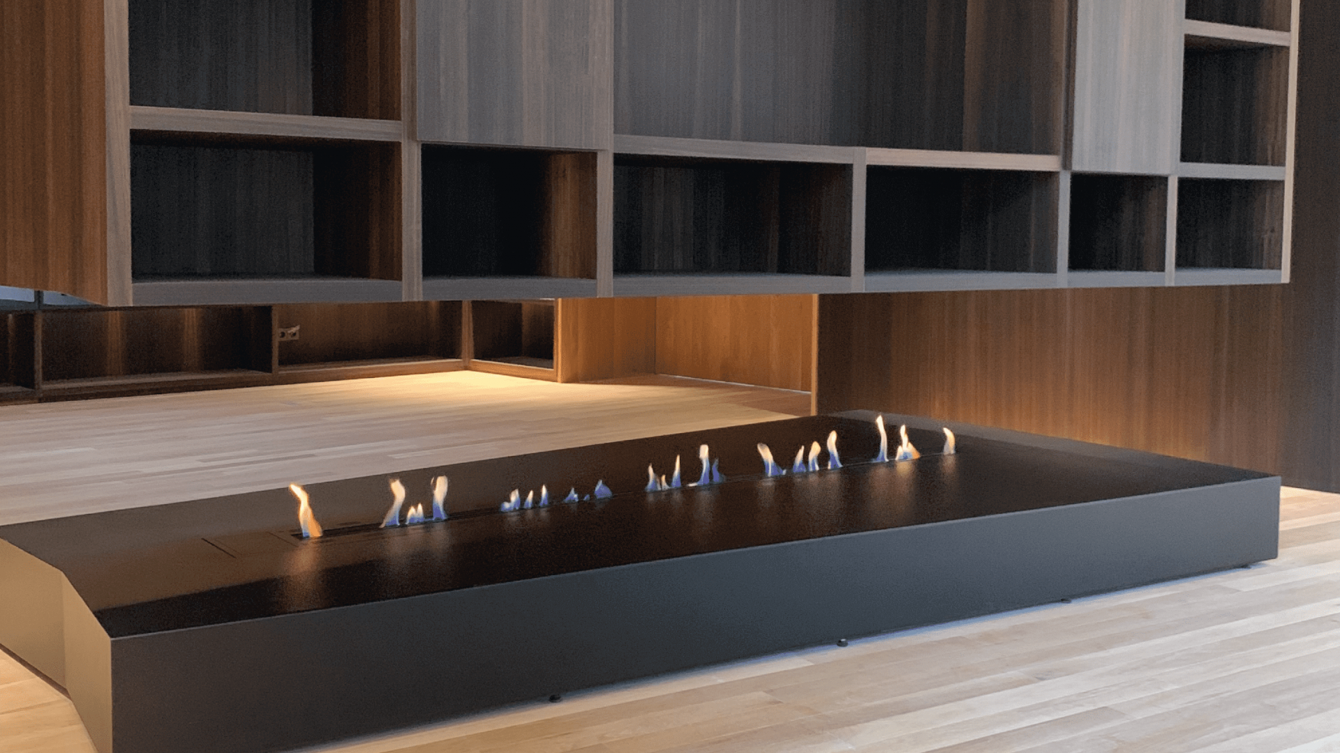 Fire Line bioethanol fireplace integrated into a modern open-space wooden interior by GlammFire