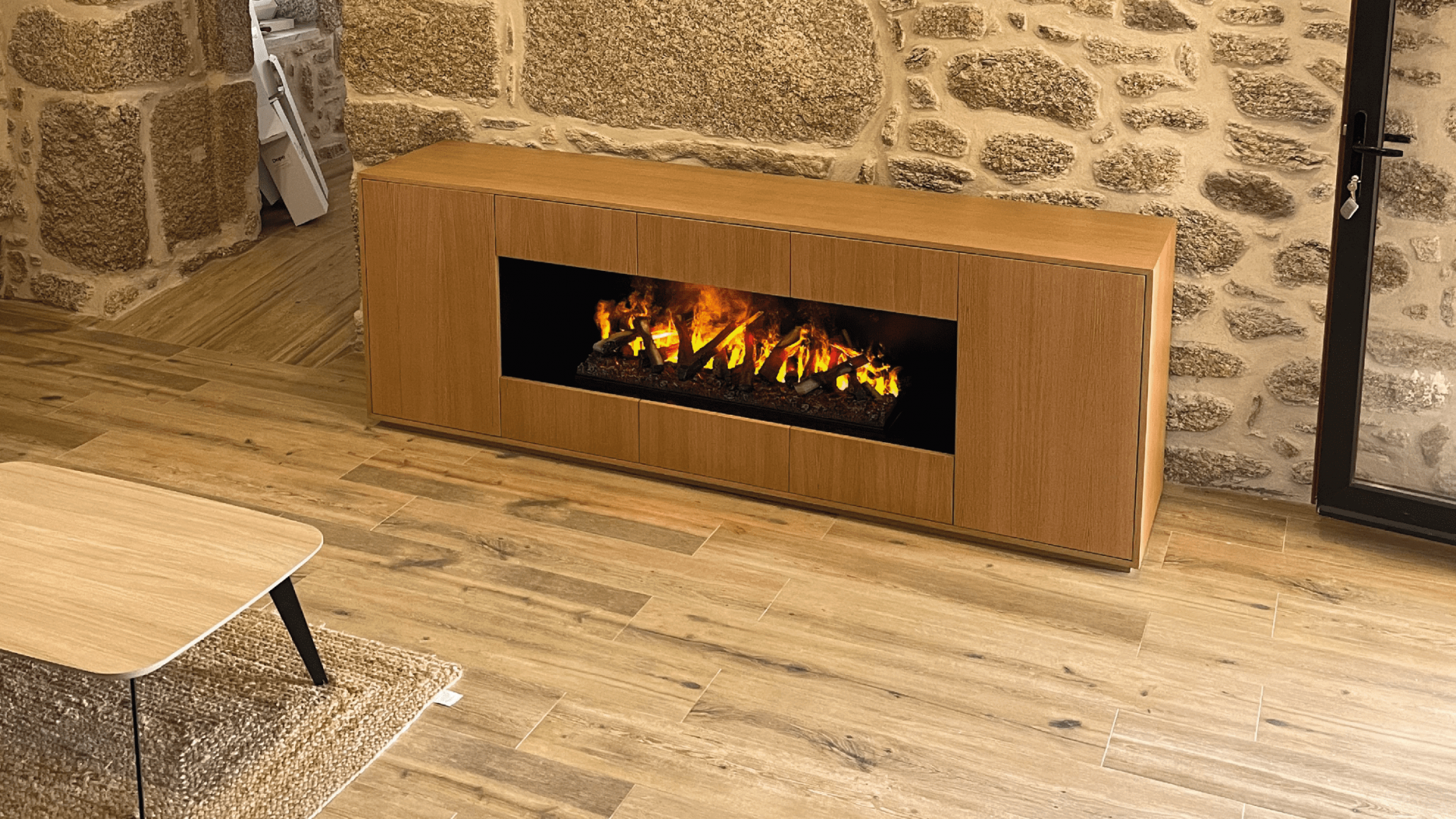 Kit-Optiv electric fireplace by GlammFire in a rustic living room with stone walls